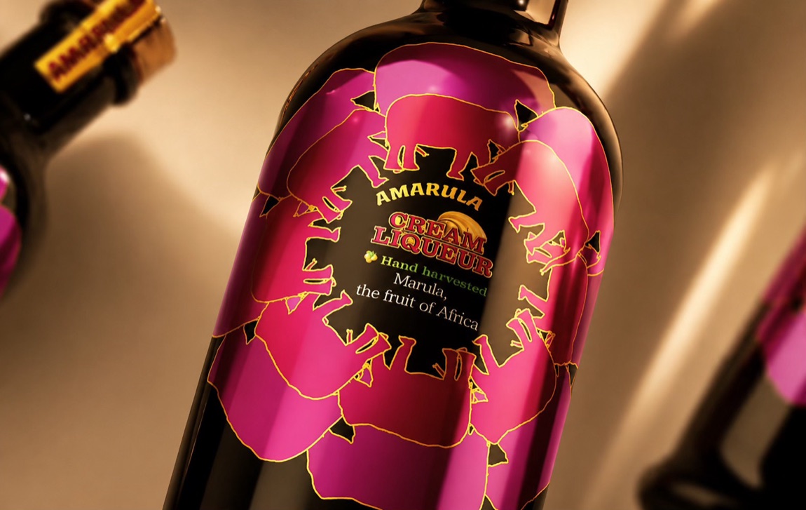 Close-up of the pink label — the elephant emblem set inside an abstract floral form.