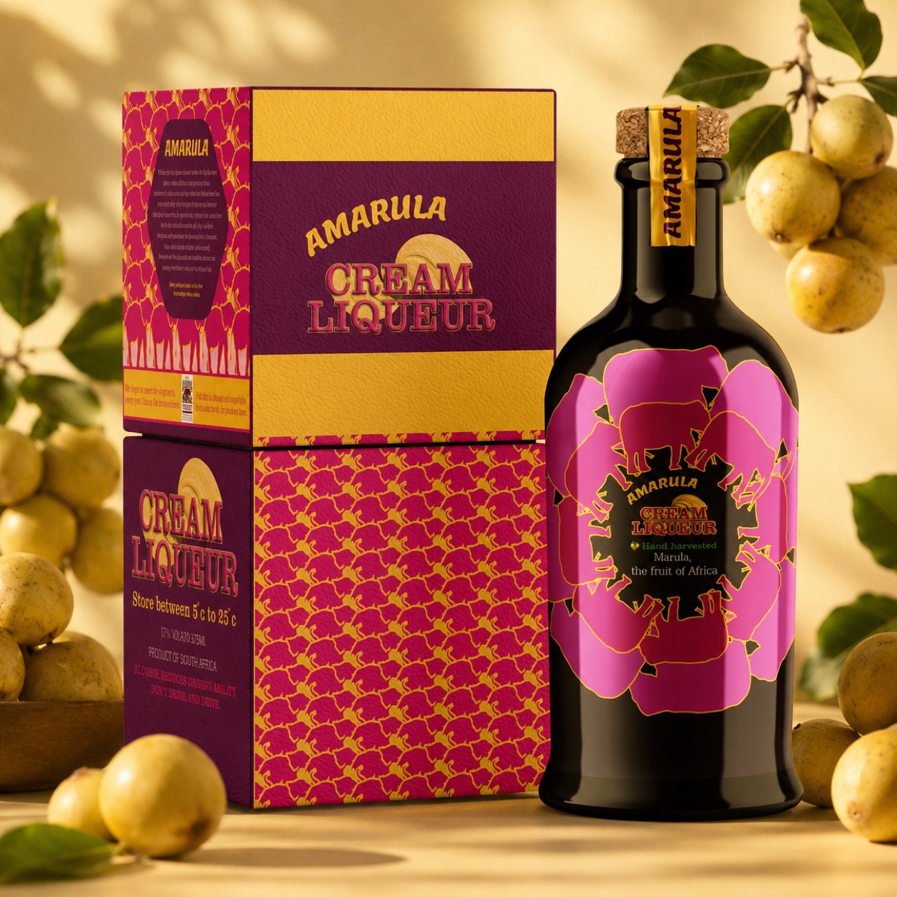 The pink and maroon Amarula bottle beside its patterned box, marula fruit scattered around them.
