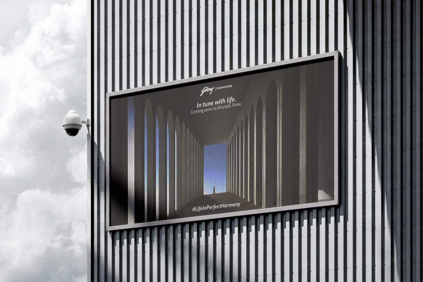 A billboard against a clouded sky, carrying an arched corridor composition in near-monochrome.
