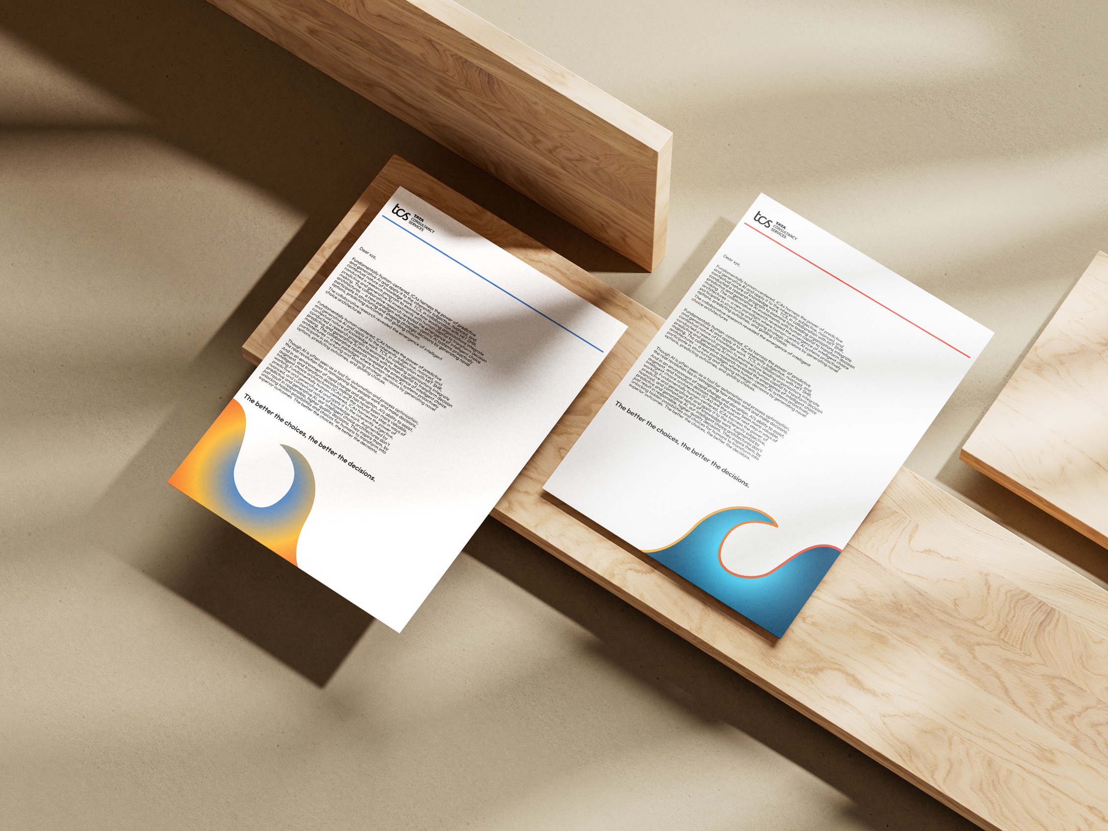 The full stationery set — letterheads and cards — arranged on wooden blocks on a pale surface.
