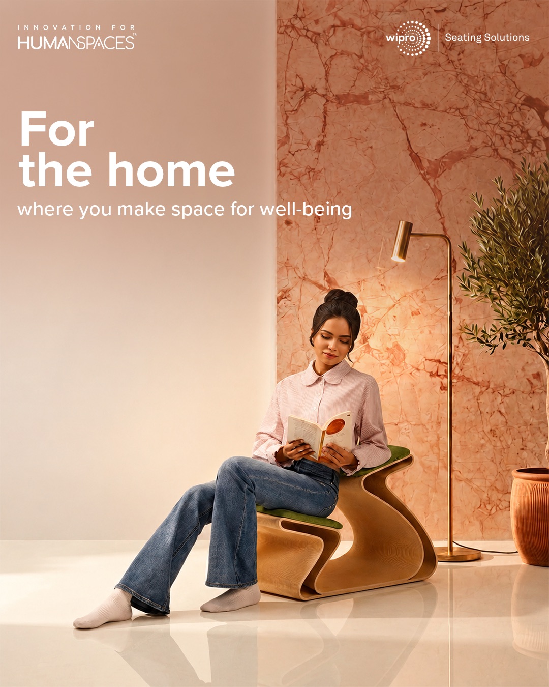 For the home, where you make space for well-being — a reader on a wooden chair beside a marble wall.