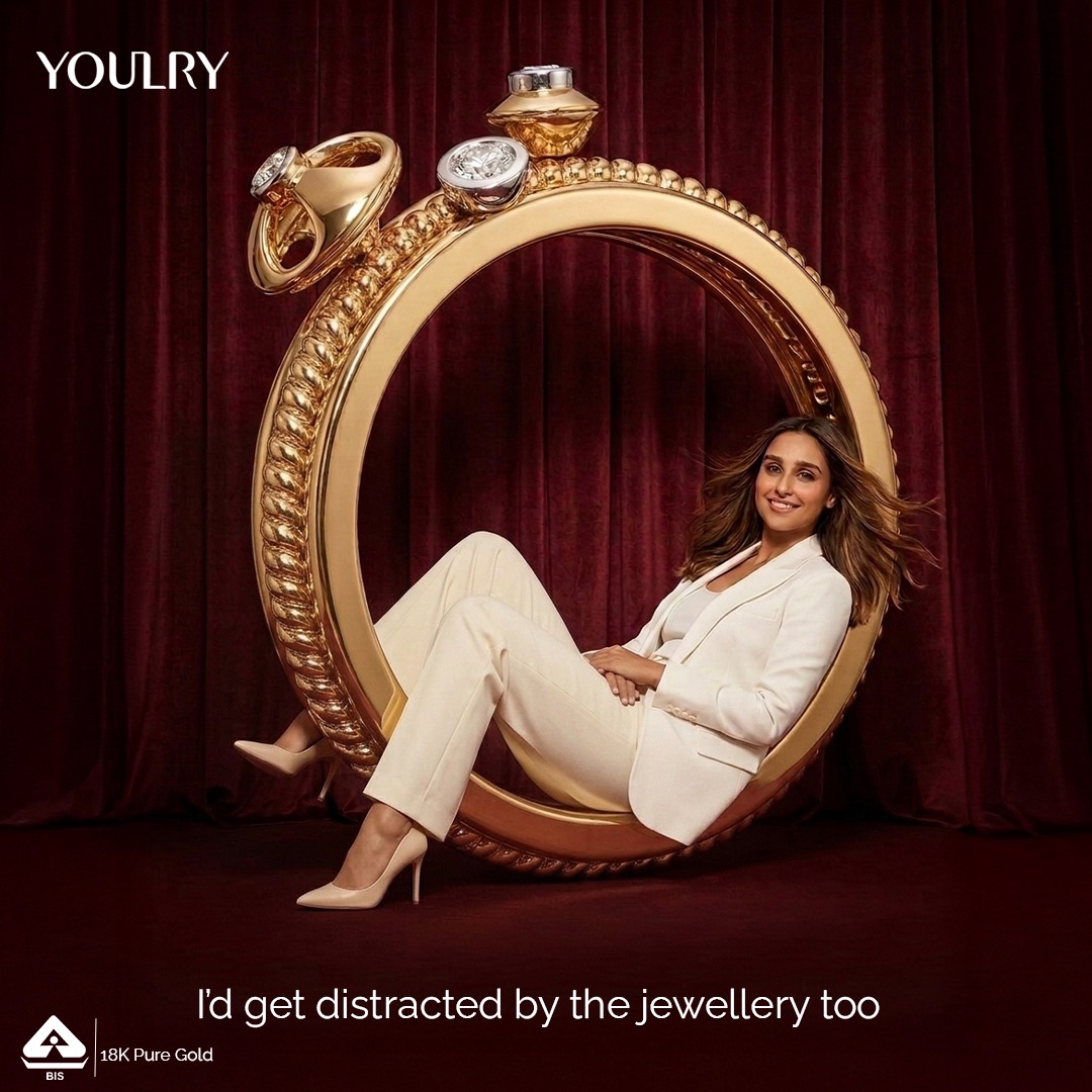Larger Than Life — a model reclining inside an oversized gold bracelet.
