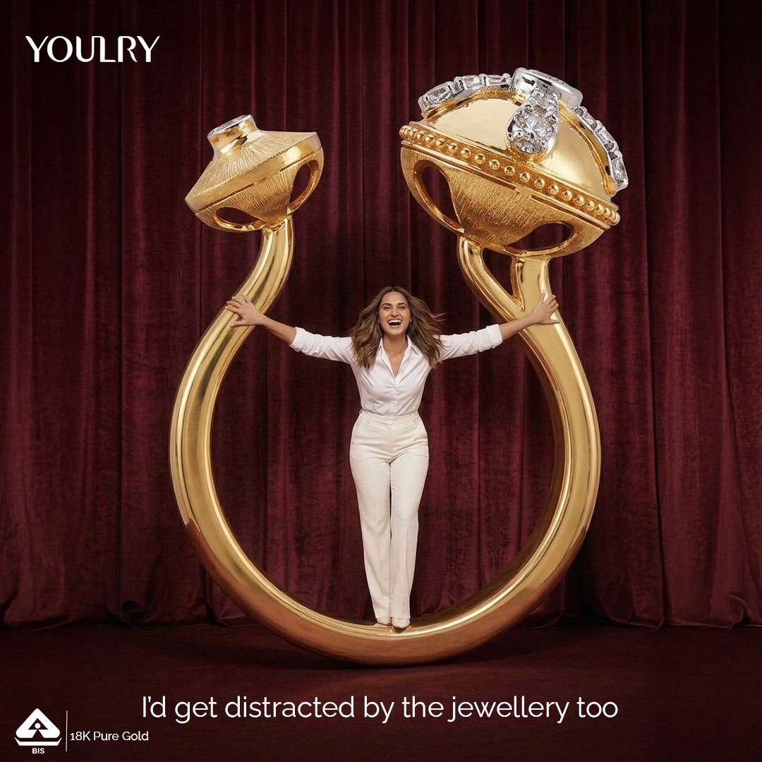 Larger Than Life — a model standing inside an oversized gold ring.